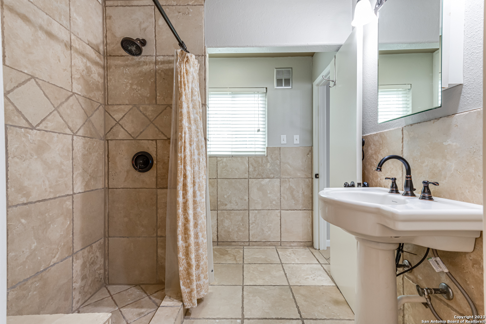 555 Patricia San Antonio, TX 78216 - Photo 16 of 33 a bathroom with a sink a toilet and shower