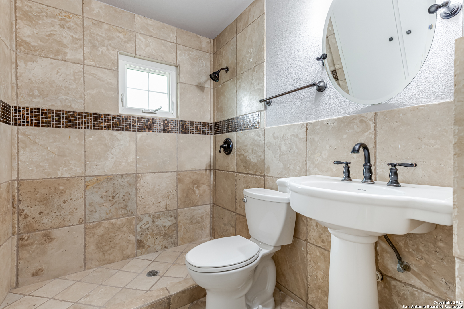 555 Patricia San Antonio, TX 78216 - Photo 24 of 33 a bathroom with a sink a toilet and a mirror