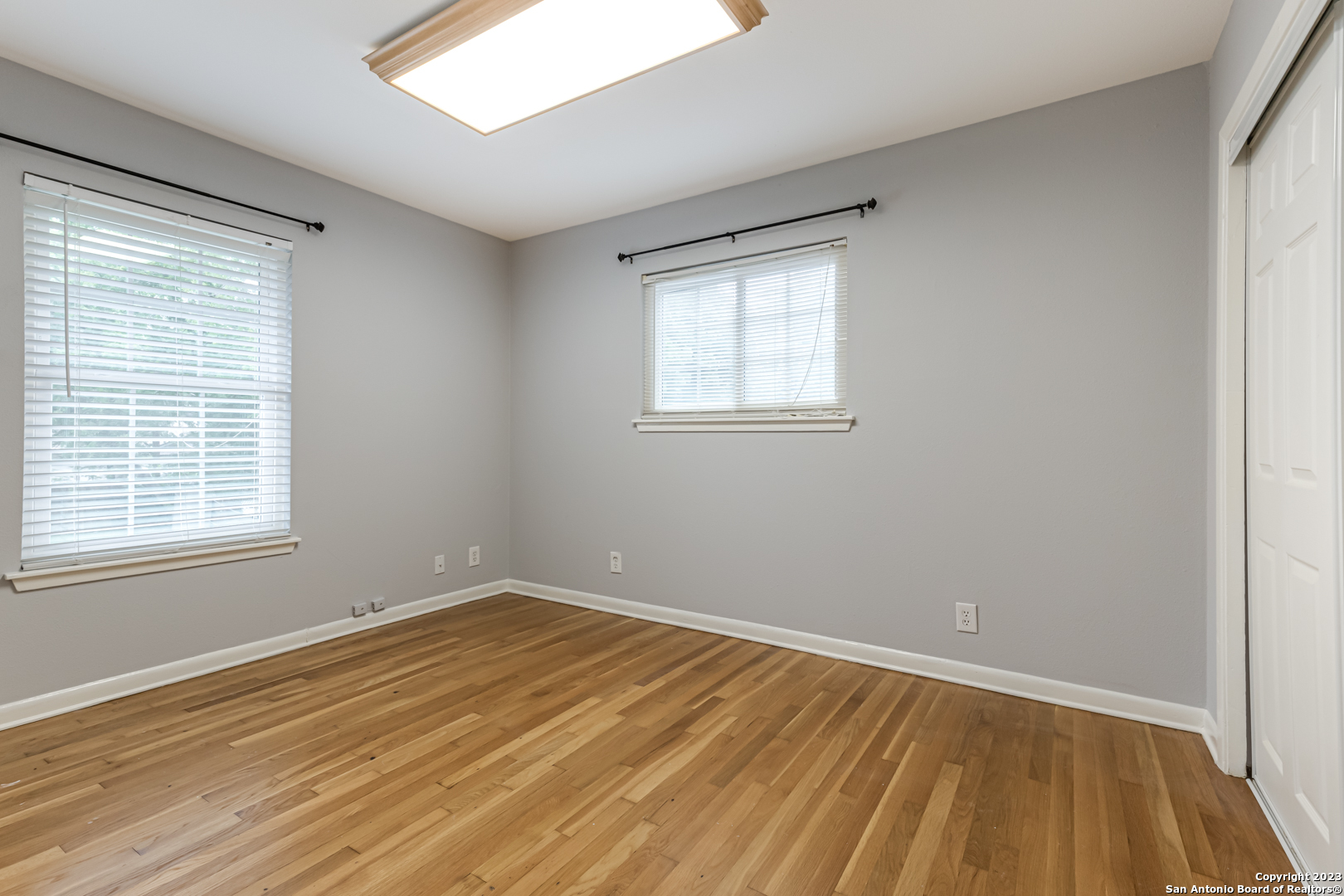 555 Patricia San Antonio, TX 78216 - Photo 25 of 33 a view of an empty room with wooden floor and a window