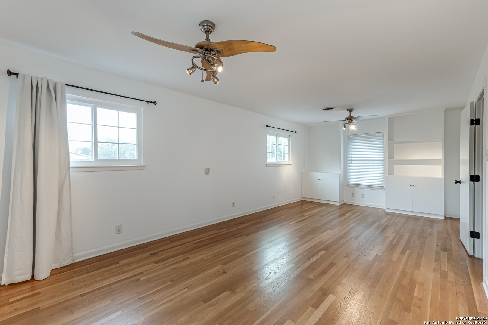555 Patricia San Antonio, TX 78216 - Photo 26 of 33 a view of empty room with wooden floor and fan