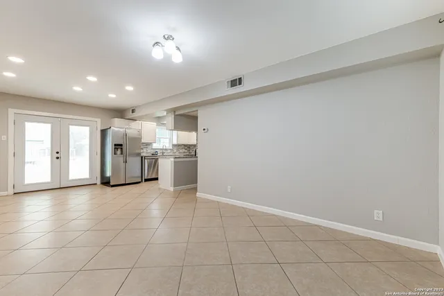 a view of an empty room with a kitchen