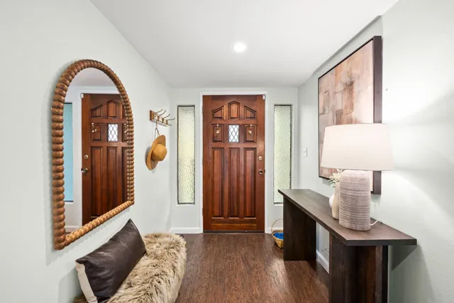a view of a dining room with furniture a chandelier and wooden floor