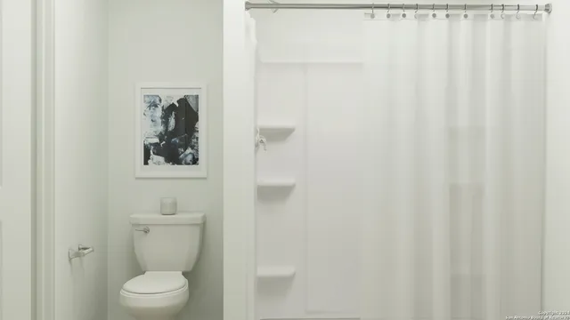 a white toilet sitting next to a white sink