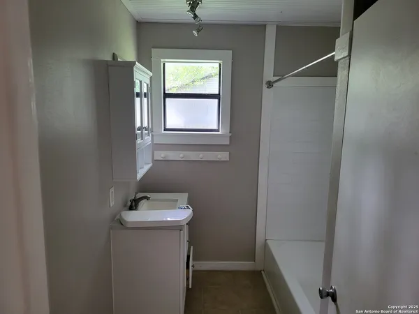 a bathroom with a sink toilet and tub
