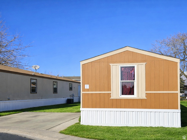 340 West 920 South, Unit 16 Provo, UT 84601 - Photo 2 of 15 View of home's exterior with a lawn and a storage unit