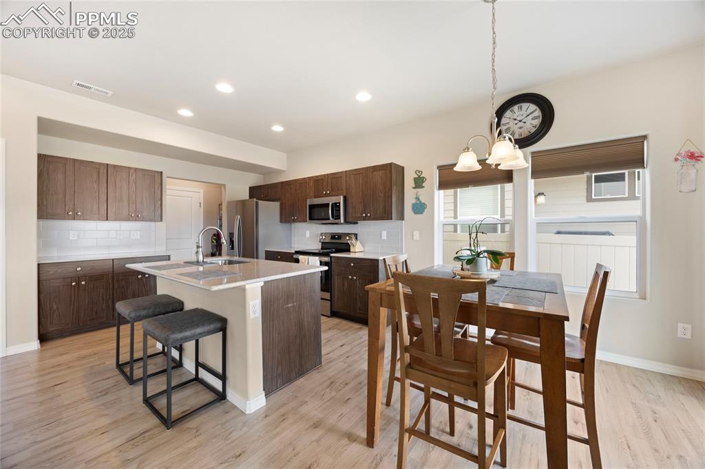 4536 Gneiss Loop Colorado Springs, CO 80938 - Photo 18 of 24 a view of a dining room with furniture window and wooden floor