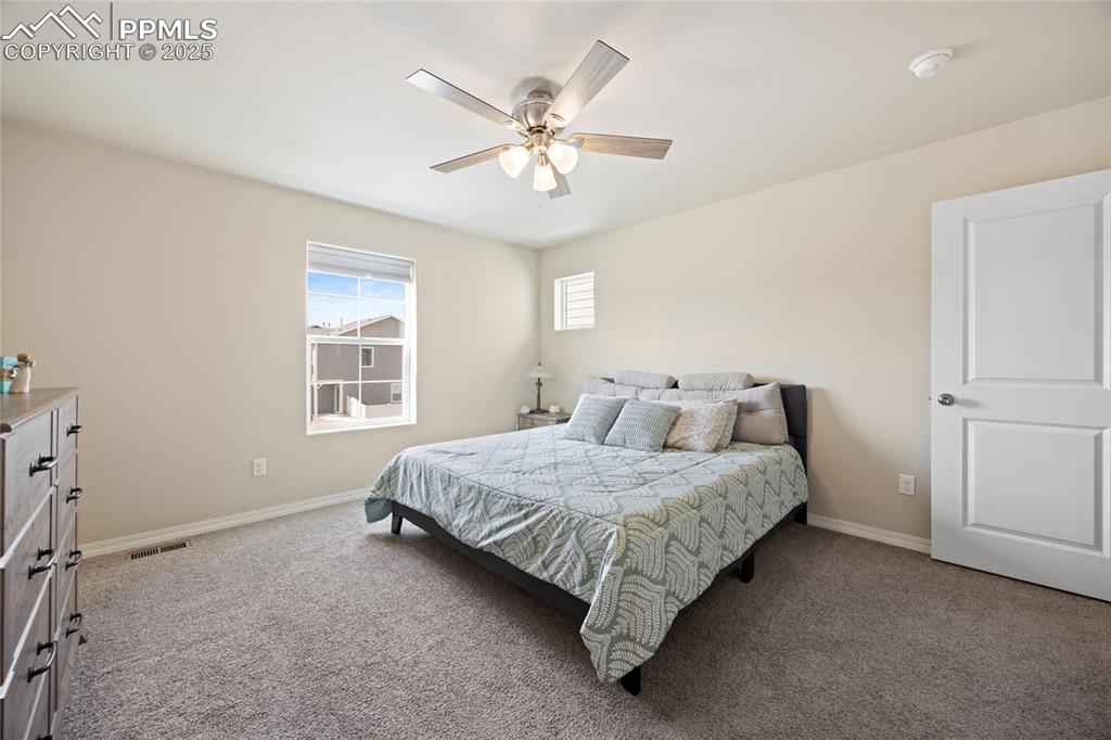 4536 Gneiss Loop Colorado Springs, CO 80938 - Photo 20 of 24 a bedroom with a bed and window