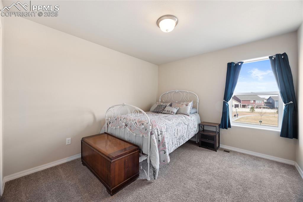 4536 Gneiss Loop Colorado Springs, CO 80938 - Photo 21 of 24 a bedroom with a bed and window