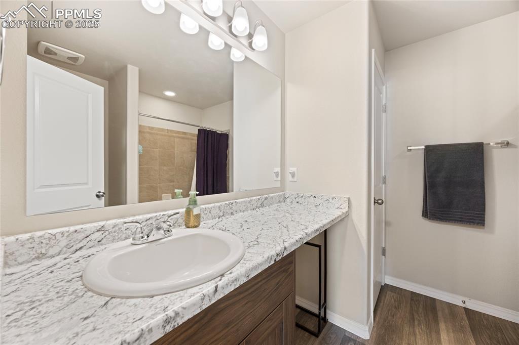 4536 Gneiss Loop Colorado Springs, CO 80938 - Photo 22 of 24 a bathroom with a granite countertop sink and a mirror