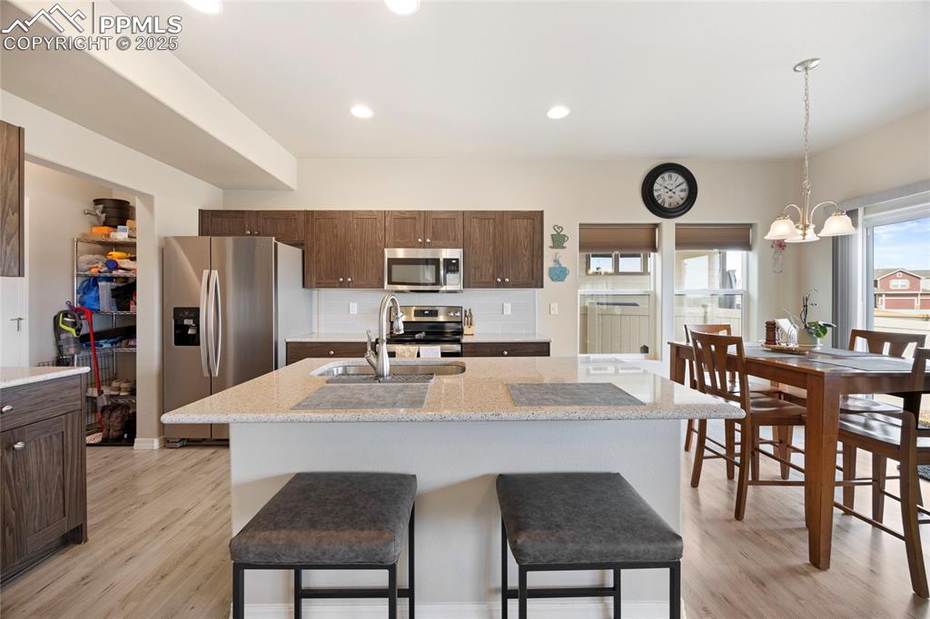 4536 Gneiss Loop Colorado Springs, CO 80938 - Photo 3 of 24 a large kitchen with a table and chairs