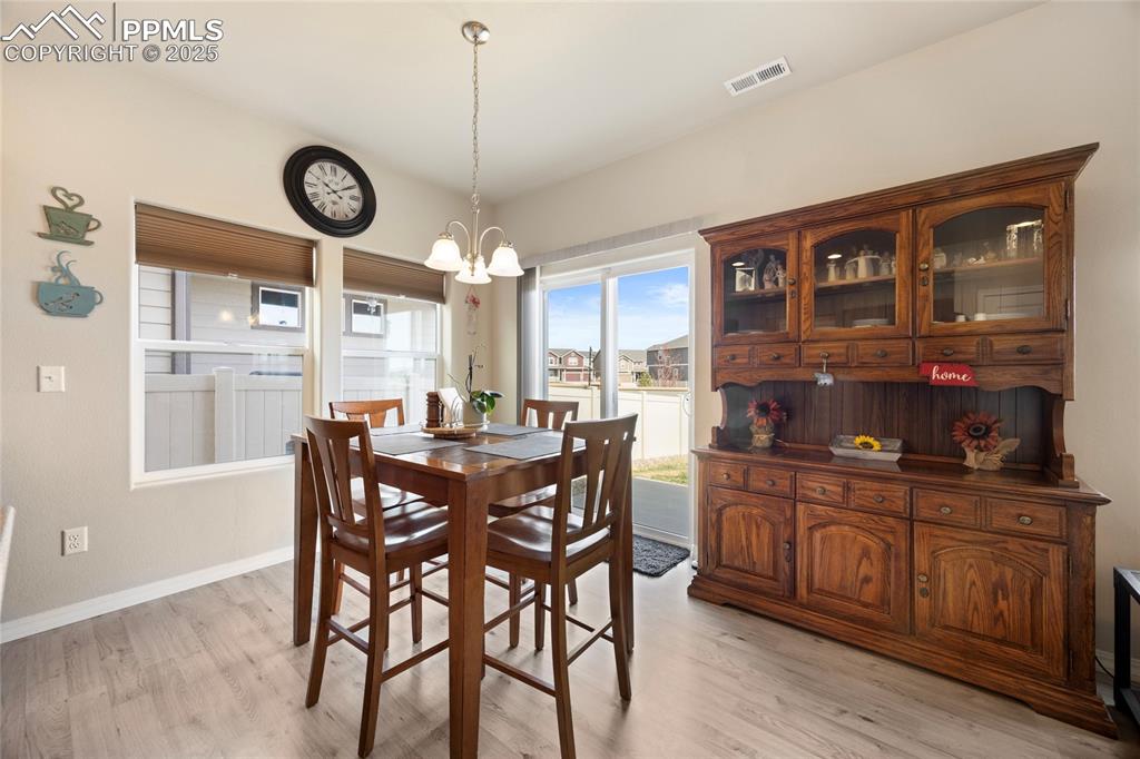 4536 Gneiss Loop Colorado Springs, CO 80938 - Photo 8 of 24 a kitchen with a table and chairs in it