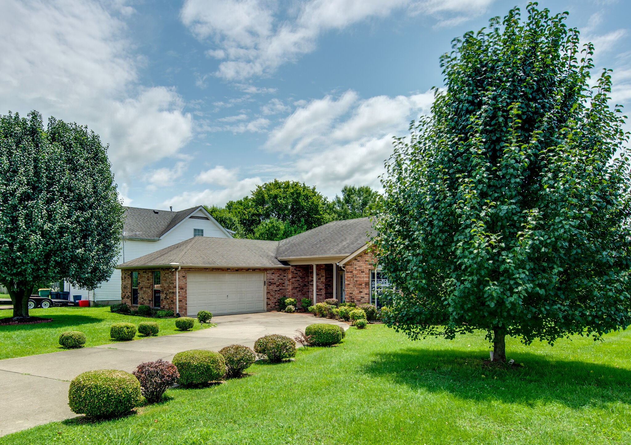 2123 Spring Hill Circle Spring Hill, TN 37174 - Photo 3 of 32 a front view of a house with garden and trees
