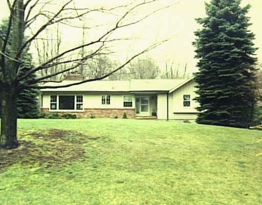 54 Old Logging Road Stamford, CT 06903 - Photo 1 of 1 a front view of a house with a garden