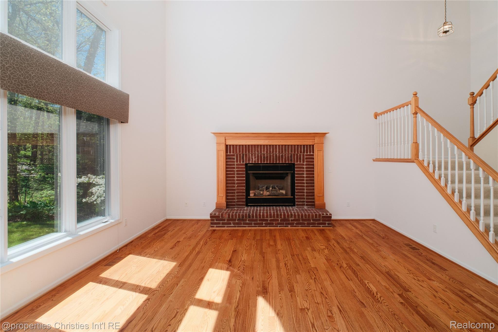 2005 North Splitstone Pinckney, MI 48169 - Photo 20 of 57 Great room with cozy fireplace and views to back yard