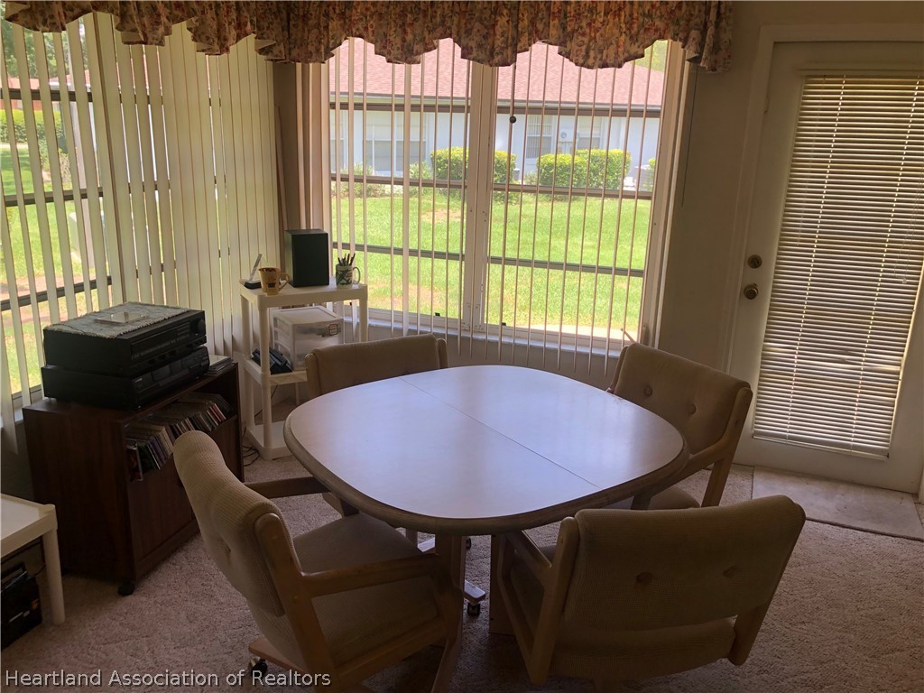 2510 Davis Circle Sebring, FL 33870 - Photo 14 of 23 a view of a dining room with furniture and a window