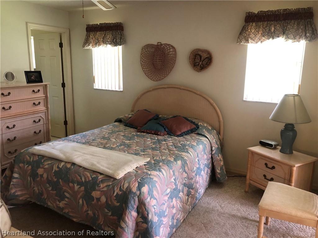 2510 Davis Circle Sebring, FL 33870 - Photo 7 of 23 a bedroom with a bed and window