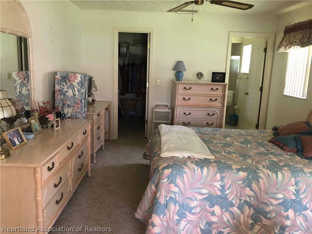 2510 Davis Circle Sebring, FL 33870 - Photo 8 of 23 a bedroom with a bed and a dresser