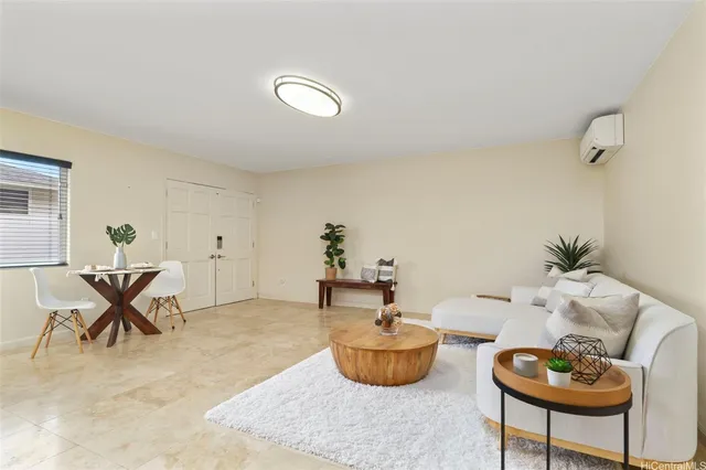 a living room with furniture and a potted plant