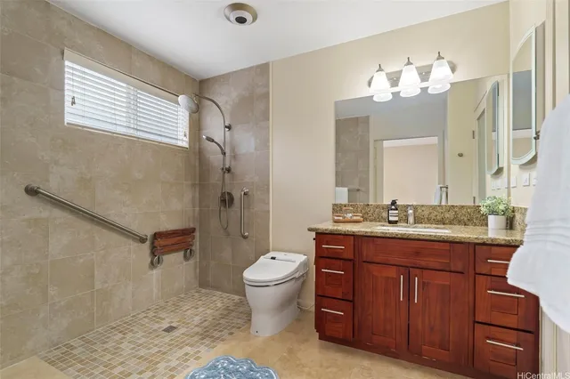 a bathroom with a granite countertop sink toilet and shower