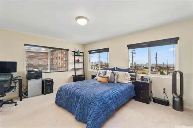 a bedroom with a large bed and a view of kitchen