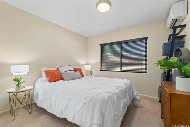 a bedroom with a bed and a potted plant