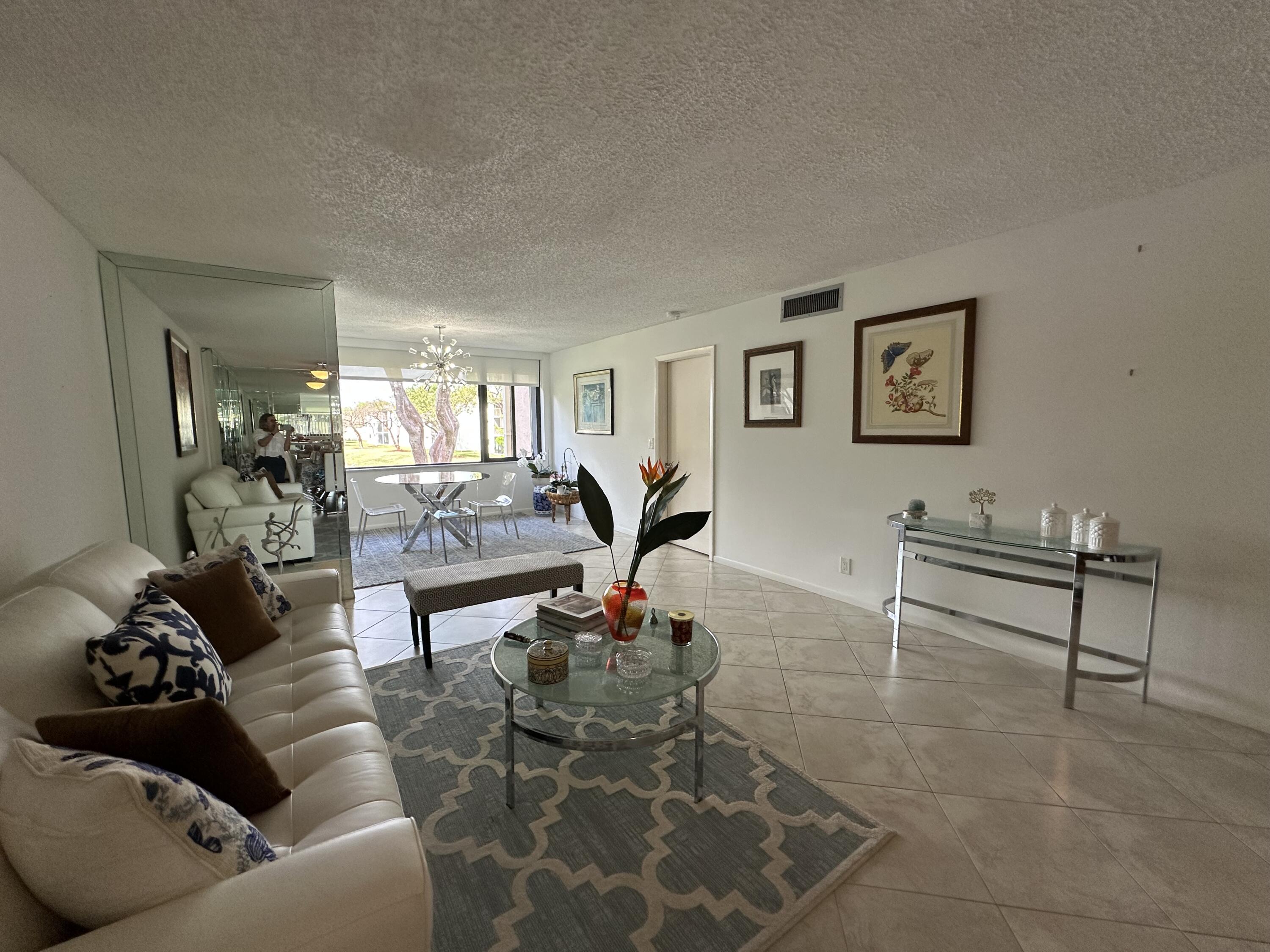 15075 Witney Road, Unit 211 Delray Beach, FL 33484 - Photo 8 of 23 a living room with furniture and wooden floor