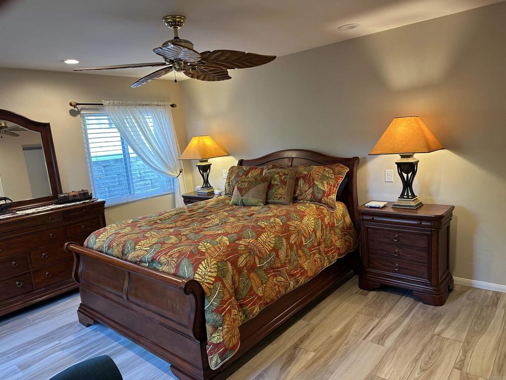 1001 Riverview Drive Fallbrook, CA 92028 - Photo 14 of 36 a bed sitting in a room next to a lamp