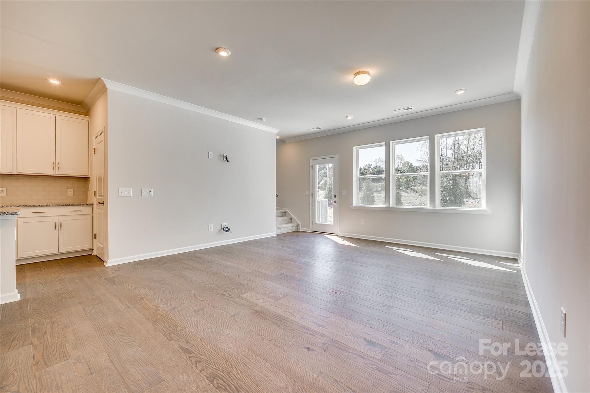 229 Brooks Springs Drive, Unit 34 Fort Mill, SC 29708 - Photo 12 of 31 an empty room with wooden floor and windows