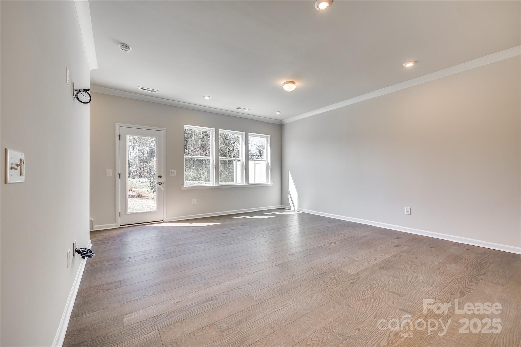 229 Brooks Springs Drive, Unit 34 Fort Mill, SC 29708 - Photo 13 of 31 wooden floor in an empty room with a window