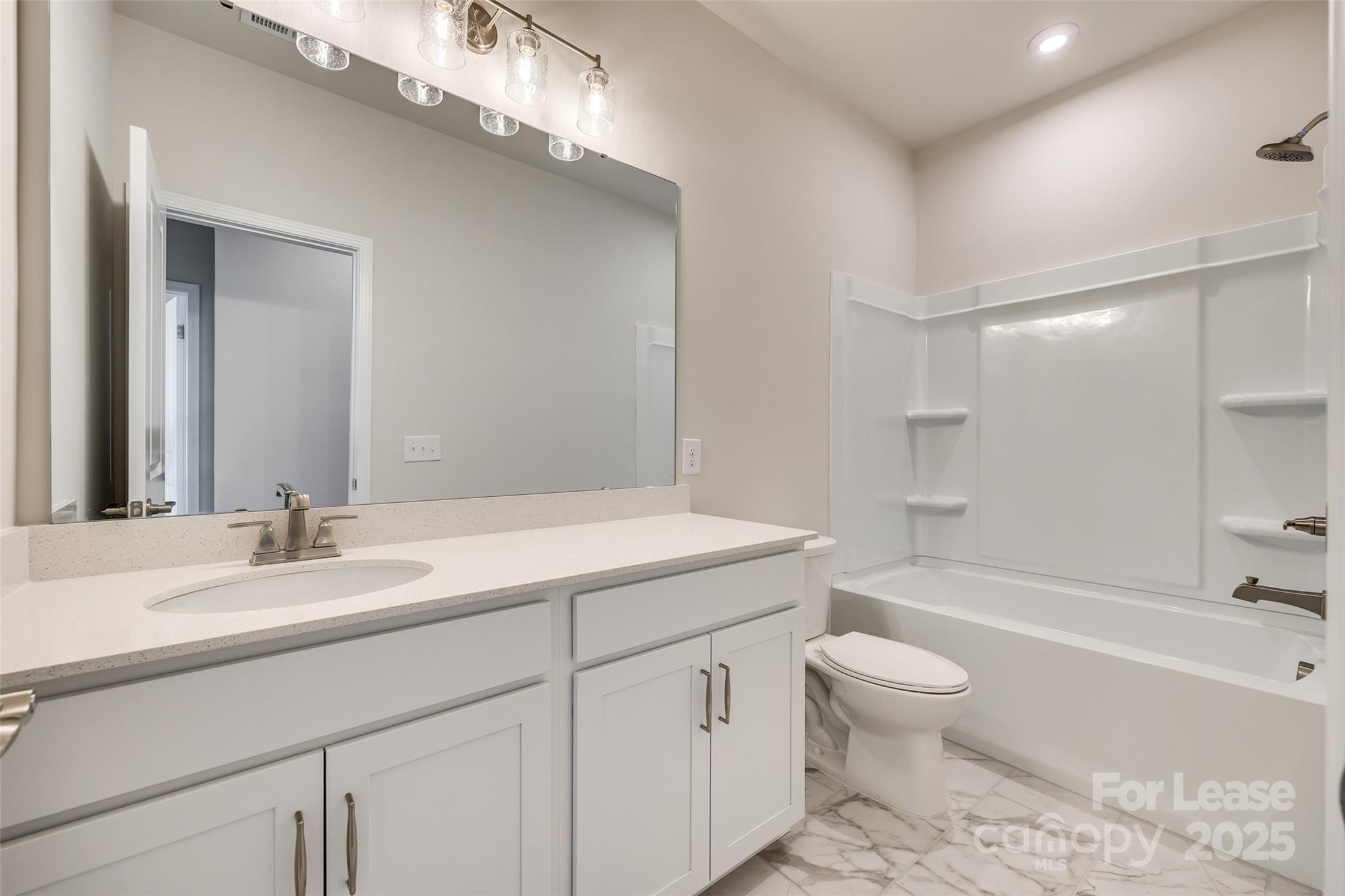 229 Brooks Springs Drive, Unit 34 Fort Mill, SC 29708 - Photo 26 of 31 a bathroom with a sink a toilet and bathtub