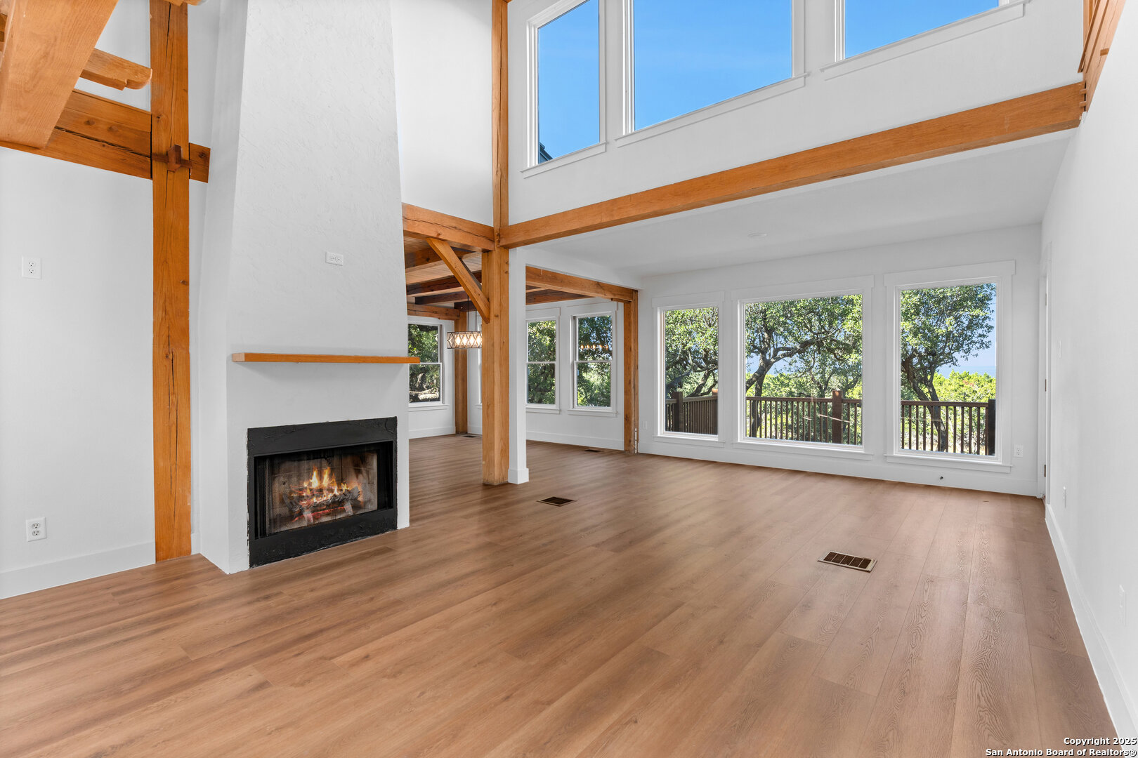 101 Ranch View Boerne, TX 78006 - Photo 19 of 63 a view of an empty room with wooden floor fireplace and a window