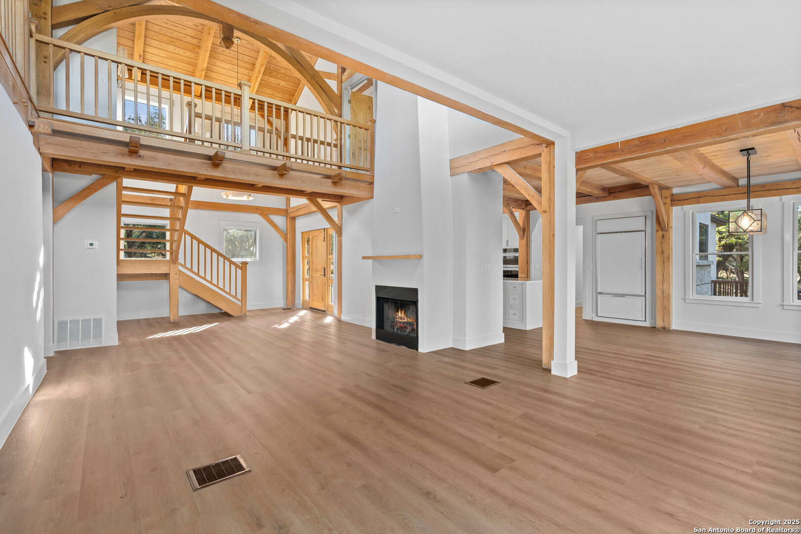 101 Ranch View Boerne, TX 78006 - Photo 21 of 63 an empty room with wooden floor fireplace and windows