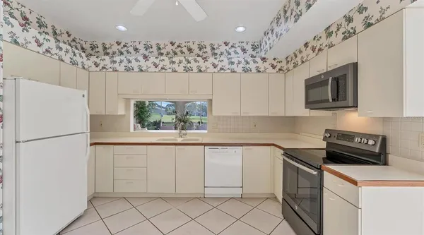 a kitchen with a white stove top oven and refrigerator