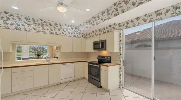 a kitchen with a sink appliances and cabinets