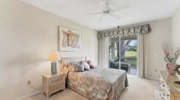 a bedroom with a bed and a large window with the outer view