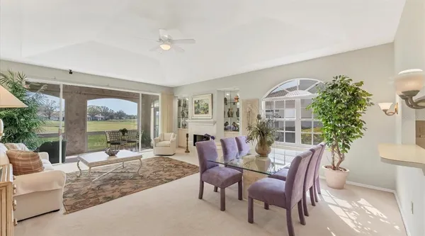 a view of a livingroom with furniture and floor to ceiling window