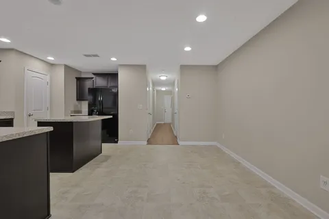 a kitchen with kitchen island a sink stainless steel appliances and cabinets