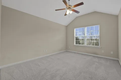 an empty room with fan and a ceiling fan
