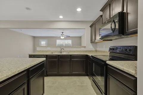 a kitchen with a sink and stainless steel appliances