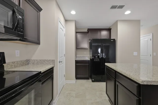 a kitchen with a sink and refrigerator