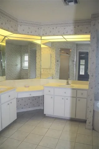a bathroom with a sink a bathtub and a vanity
