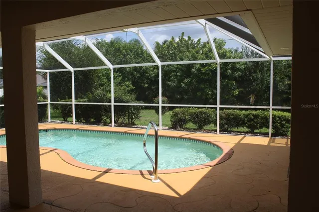 a view of a room with a window and wooden floor