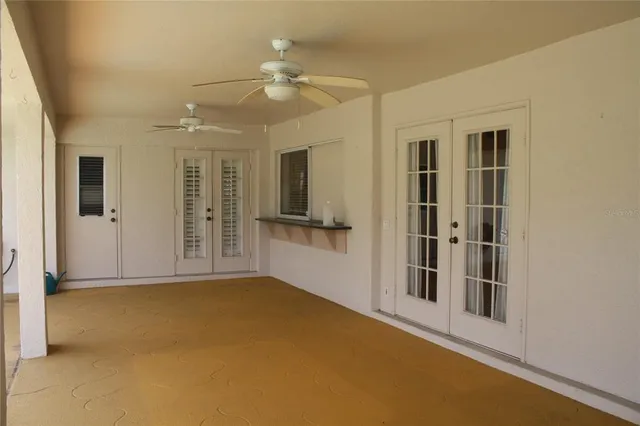 a view of a livingroom with a ceiling fan and window