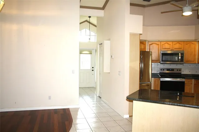 a kitchen with granite countertop a refrigerator and a stove