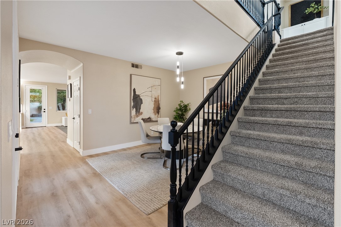 1662 Ravanusa Drive Henderson, NV 89052 - Photo 69 of 74 A striking staircase with dark railings defines this home's welcoming entry and open living area.