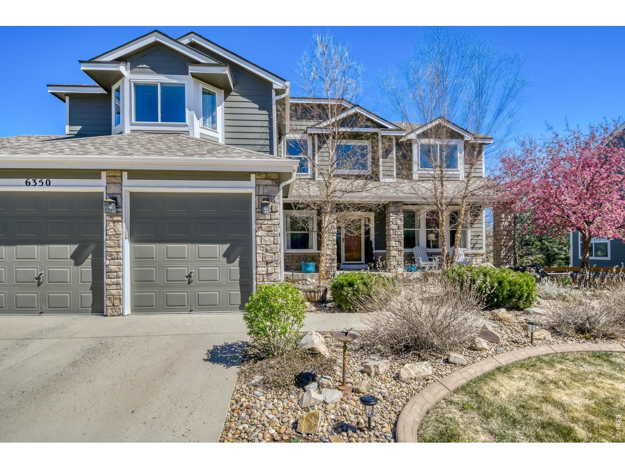 6350 Wier Way Arvada, CO 80403 - Photo 1 of 38 a front view of a house with a yard and garage