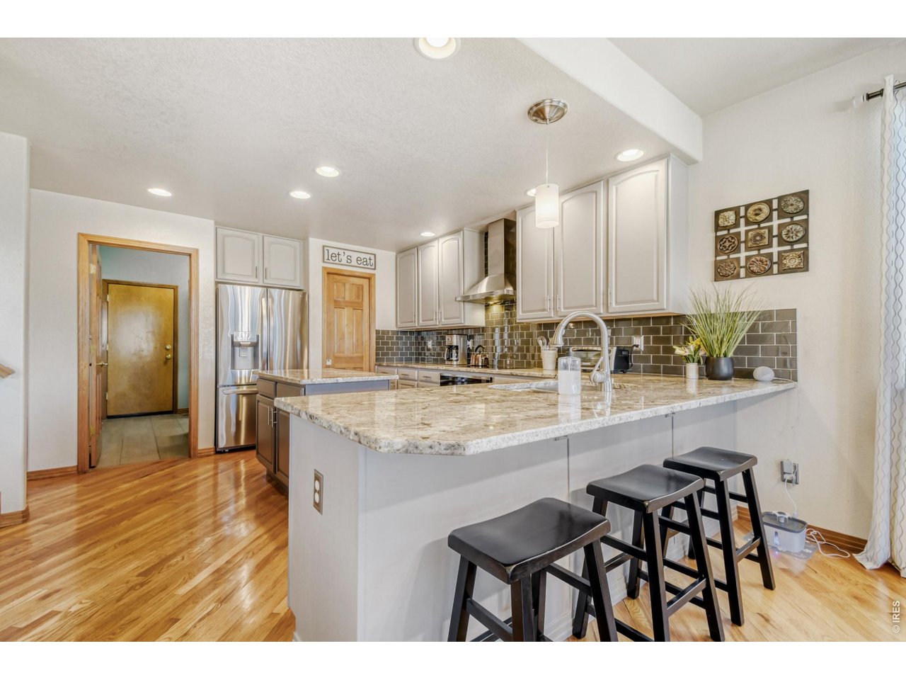 6350 Wier Way Arvada, CO 80403 - Photo 16 of 38 a kitchen with stainless steel appliances granite countertop a sink and cabinets