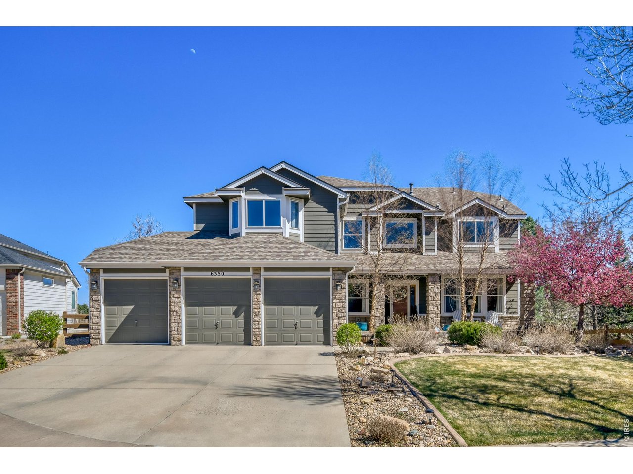 6350 Wier Way Arvada, CO 80403 - Photo 2 of 38 a front view of a house with a garden