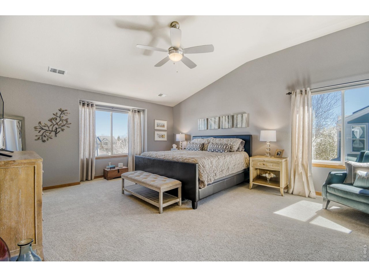 6350 Wier Way Arvada, CO 80403 - Photo 21 of 38 a bedroom with a bed and a chandelier