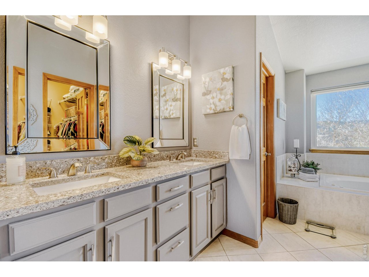 6350 Wier Way Arvada, CO 80403 - Photo 22 of 38 a bathroom with a granite countertop sink mirror and a shower
